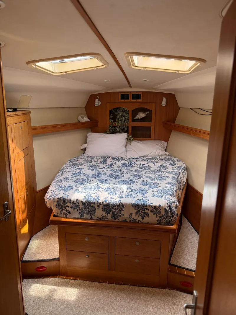 Slide: The Image of Cozy cabin interior of 2001 Hunter 460 sailboat with floral bedding and wooden furnishings. - 20