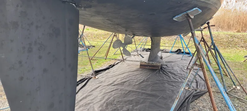 Slide: The Image of Bottom view of a 2001 Hunter 460 sailboat on stands, showing keel and propeller. - 4