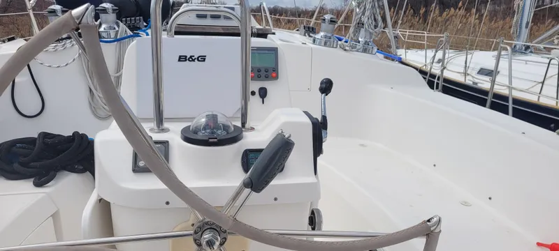 Slide: The Image of Cockpit of a 2001 Hunter 460 sailboat with steering wheel and navigation equipment. - 8
