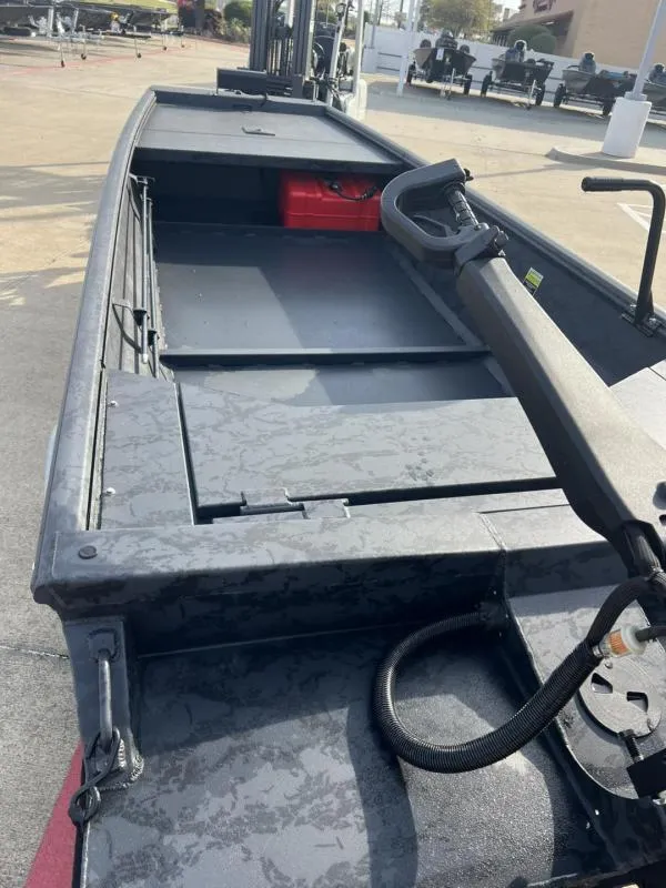 Slide: The Image of 2025 Gator Tail 17/54 Extreme Series boat interior with steering handle and storage compartment. - 15