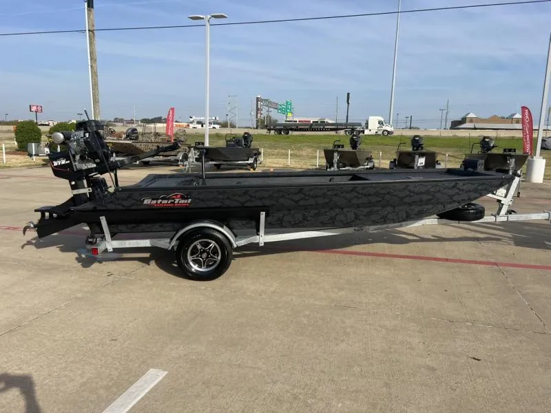 Slide: The Image of 2025 Gator Tail 17/54 Extreme Series boat on trailer in parking lot. - 6