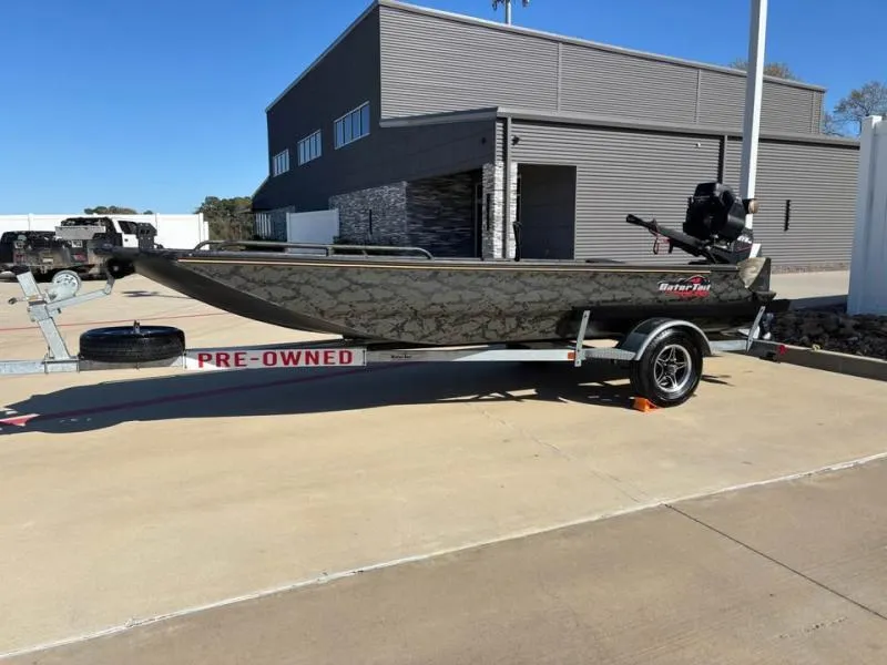 Slide: The Image of 2025 Gator Tail 17/50 Mid-Deck Savage Series boat on pre-owned trailer, parked outdoors. - 4
