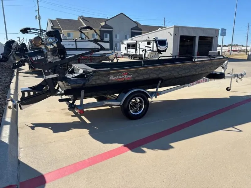 Slide: The Image of 2025 Gator Tail 17/50 Mid-Deck Savage Series boat on trailer in parking lot. - 6