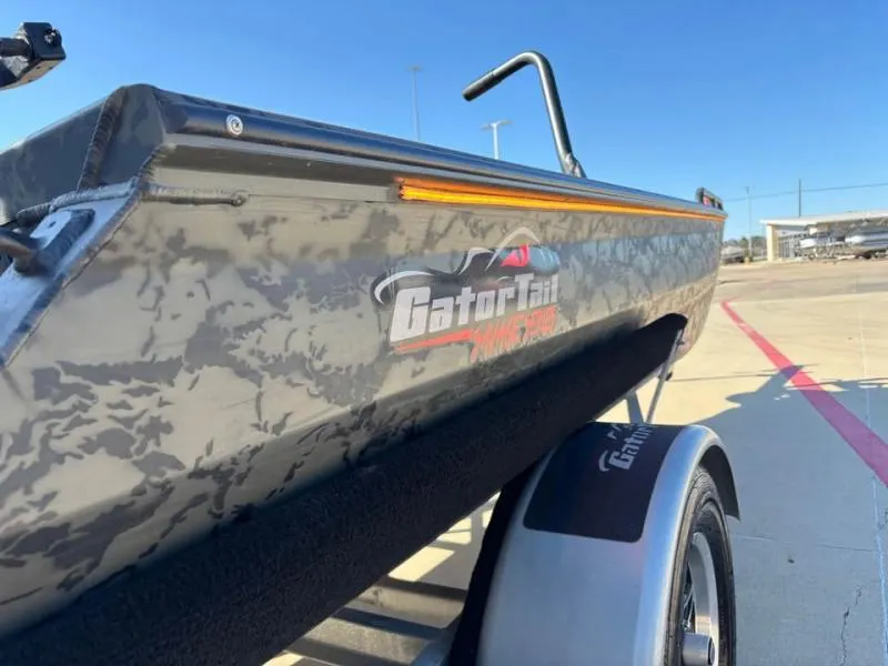 Slide: The Image of 2025 Gator Tail 17/50 MID-DECK SAVAGE SERIES boat on trailer, side view. - 7