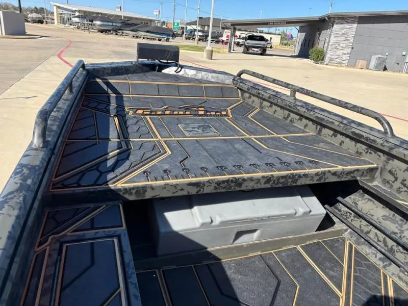 Slide: The Image of 2025 Gator Tail 17/50 MID-DECK SAVAGE SERIES boat with sleek, modern design in a parking lot. - 9