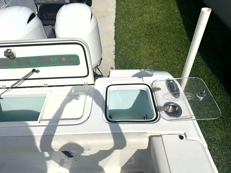 Slide: The Image of 2021 Sea Hunt Gamefish 27 boat deck with storage compartments and dual engines. - 11