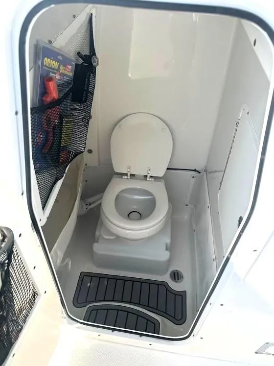 Slide: The Image of 2021 Sea Hunt Gamefish 27 boat interior with toilet and storage. - 13