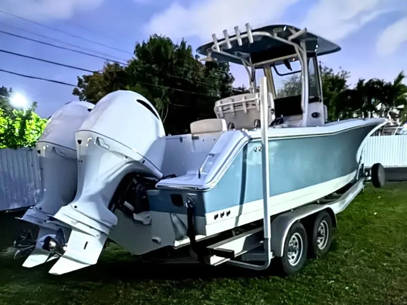 Slide: The Image of 2021 Sea Hunt Gamefish 27 with Coffin Box on trailer, featuring dual outboard engines. - 3