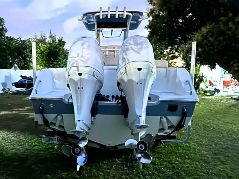 Slide: The Image of 2021 Sea Hunt Gamefish 27 with Coffin Box, dual engines, rear view on grass. - 4