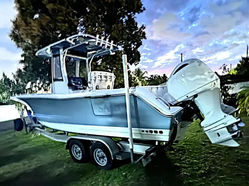 Slide: The Image of 2021 Sea Hunt Gamefish 27 with Coffin Box on trailer, parked on grass. - 5