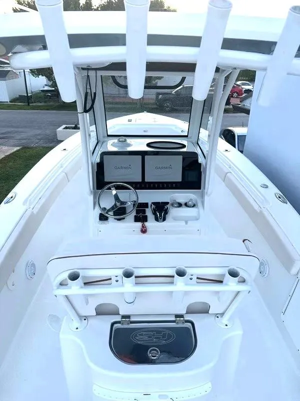 Slide: The Image of 2021 Sea Hunt Gamefish 27 with Coffin Box, featuring a sleek helm and modern controls. - 6