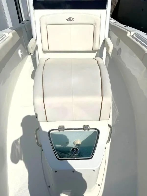 Slide: The Image of 2021 Sea Hunt Gamefish 27 with Coffin Box, featuring sleek white seating and storage. - 8