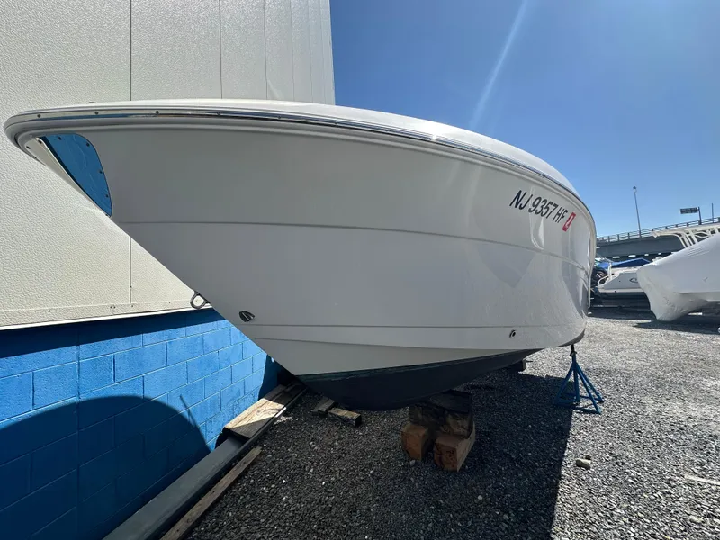 Slide: The Image of 2014 Robalo R227 Dual Console boat interior with white seating and deck. - 12