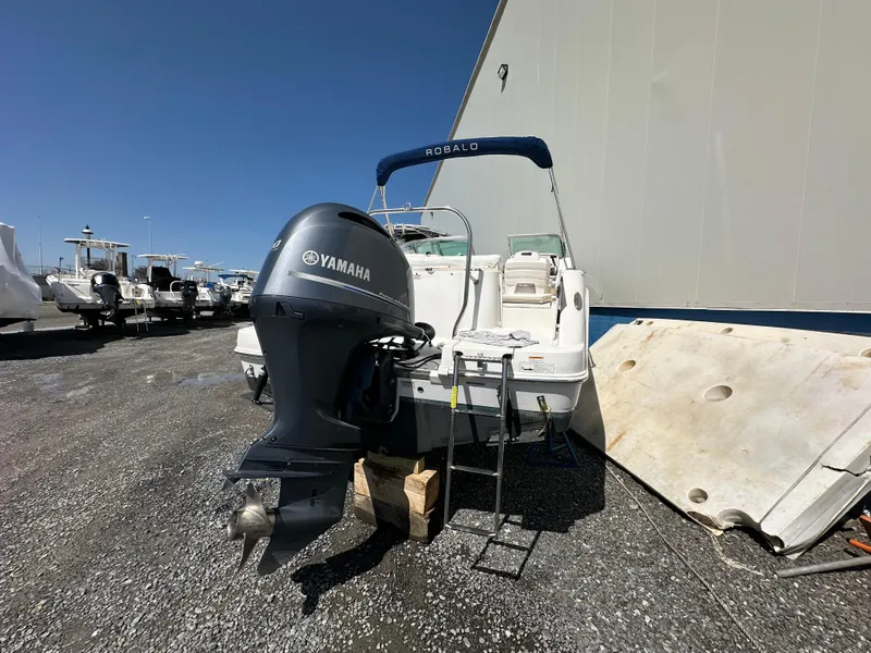 Slide: The Image of 2014 Robalo R227 Dual Console boat interior with seating and storage compartments. - 13