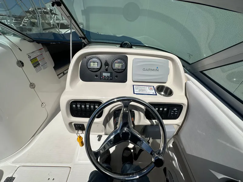 Slide: The Image of 2014 Robalo R227 Dual Console boat dashboard with Garmin navigation system and steering wheel. - 20