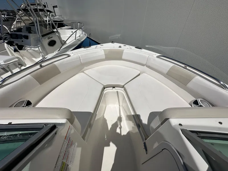 Slide: The Image of 2014 Robalo R227 Dual Console storage compartment with supplies and cushions. - 22