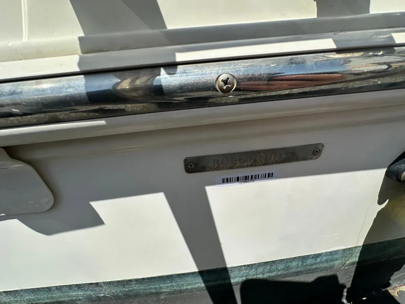 Slide: The Image of 2014 Robalo R227 Dual Console boat with metal railing and identification plate. - 31