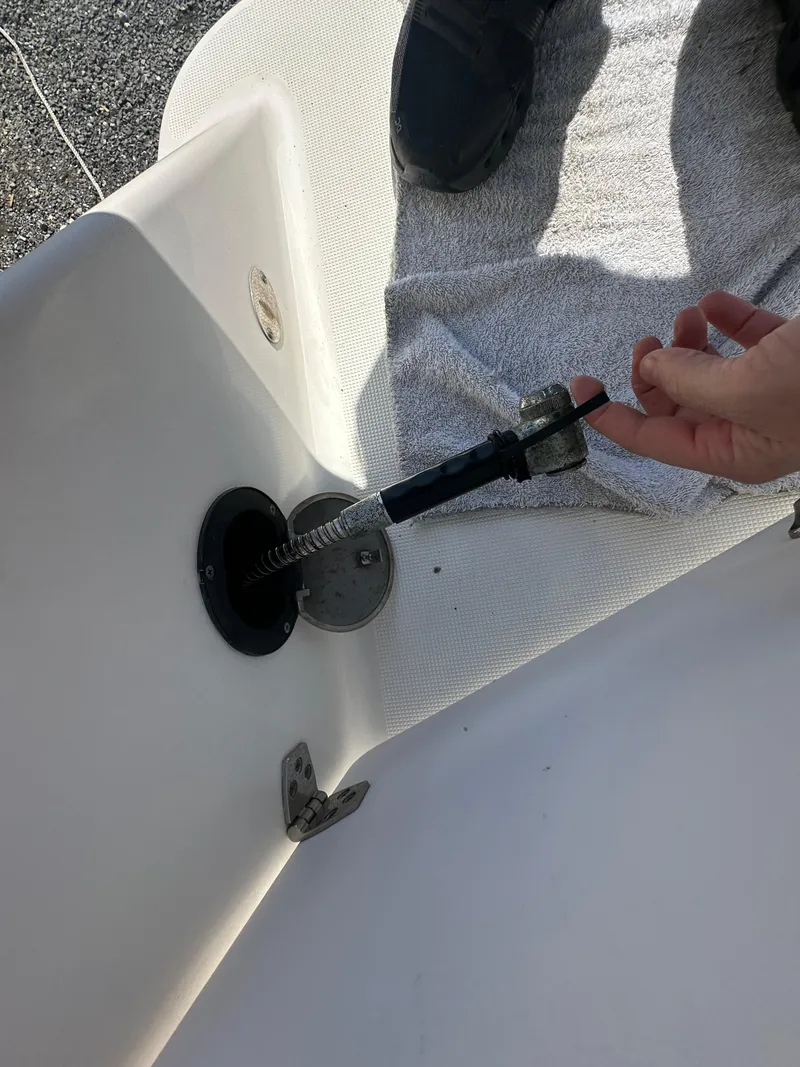 Slide: The Image of 2014 Robalo R227 Dual Console boat detail with hand adjusting a component. - 34