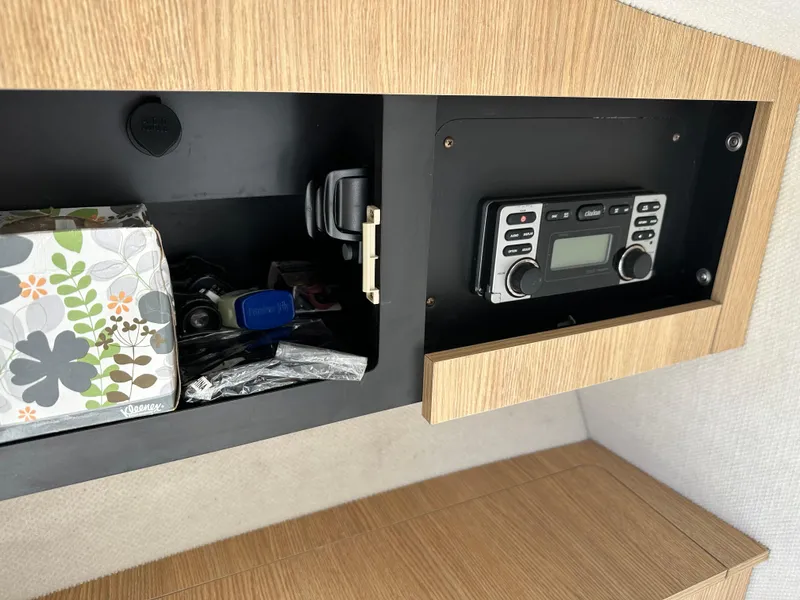 Slide: The Image of Wooden cabinet with radio and storage in 2014 Robalo R227 Dual Console boat. - 36