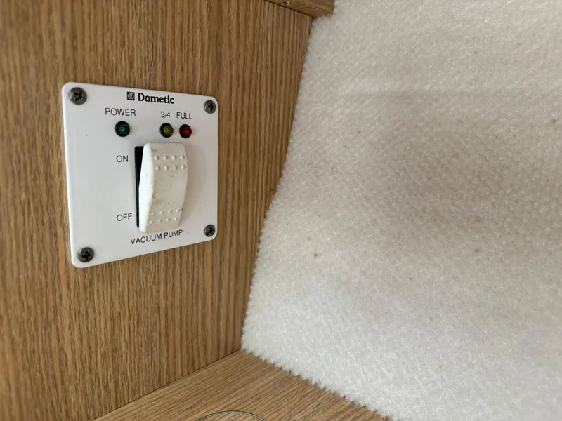 Slide: The Image of Control panel for Dometic vacuum pump on 2014 Robalo R227 Dual Console boat. - 37