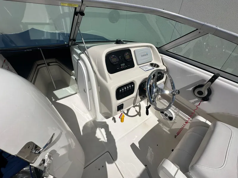 Slide: The Image of 2014 Robalo R227 Dual Console boat interior with steering wheel and dashboard controls. - 9