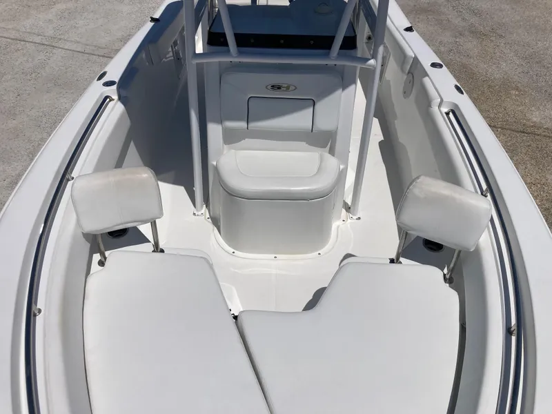 Slide: The Image of 2014 Sea Hunt 234 Ultra boat interior with white seating and storage. - 10