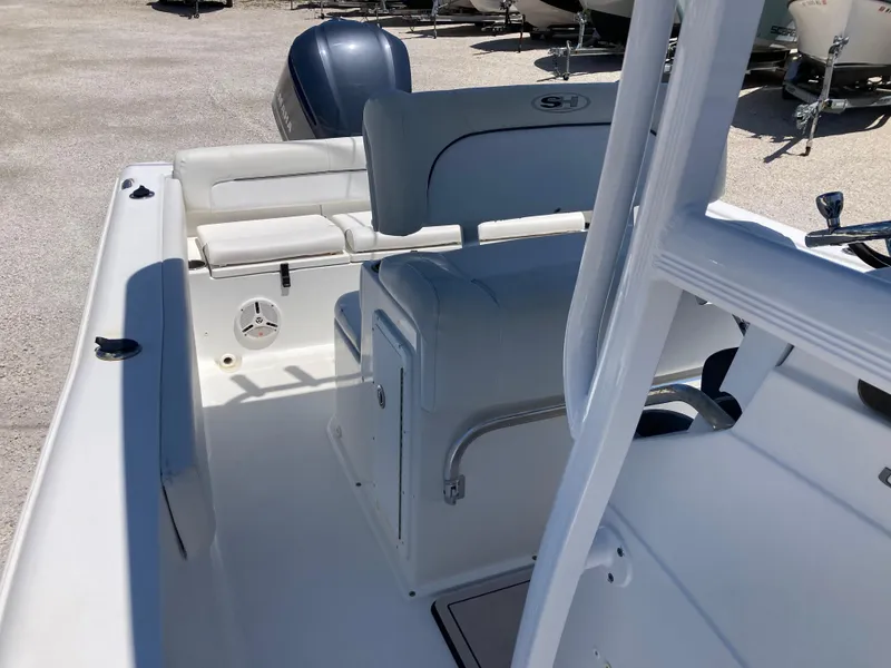 Slide: The Image of 2014 Sea Hunt 234 Ultra boat interior with seating and console, featuring a sleek design. - 12