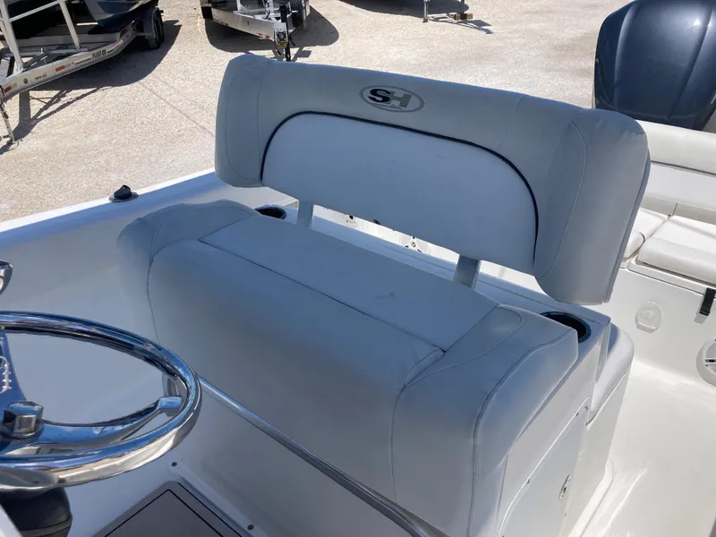 Slide: The Image of 2014 Sea Hunt 234 Ultra boat seat and steering wheel, showcasing sleek design and comfort. - 16