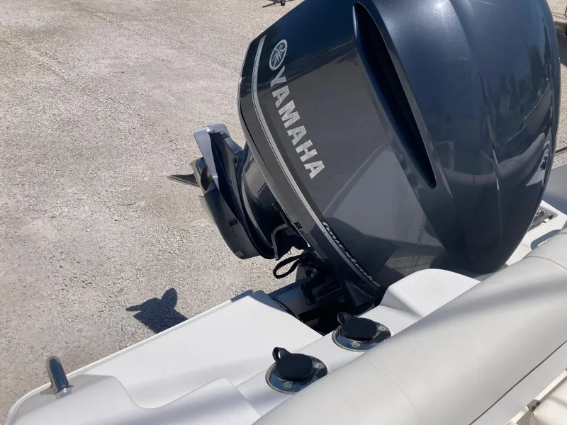Slide: The Image of 2014 Sea Hunt 234 Ultra boat with Yamaha outboard motor, viewed from the rear. - 18