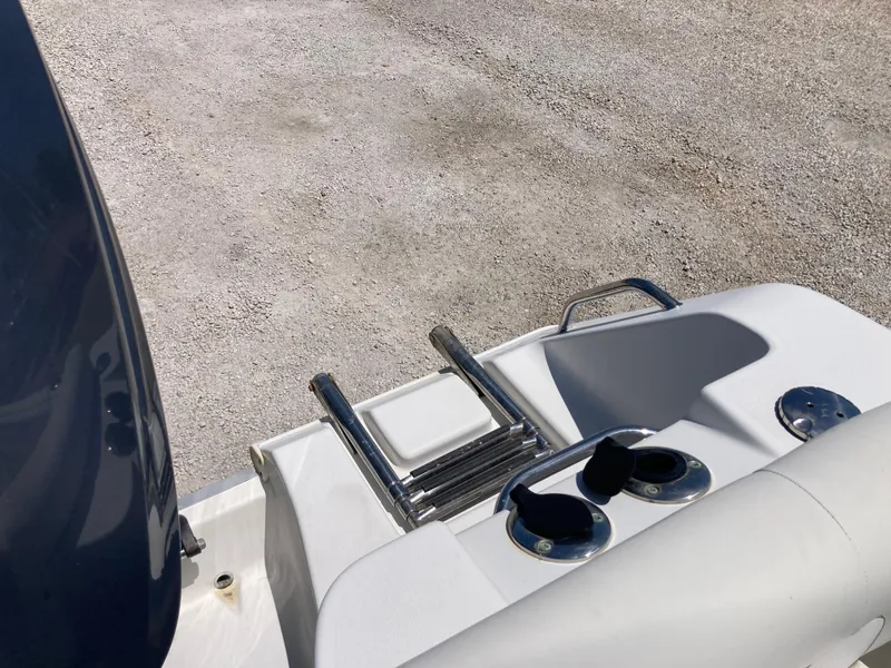 Slide: The Image of 2014 Sea Hunt 234 Ultra boat stern with ladder and rod holders. - 19