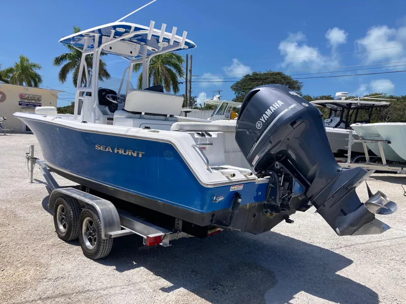 Slide: The Image of 2014 Sea Hunt 234 Ultra boat with Yamaha engine on trailer, parked outdoors. - 4