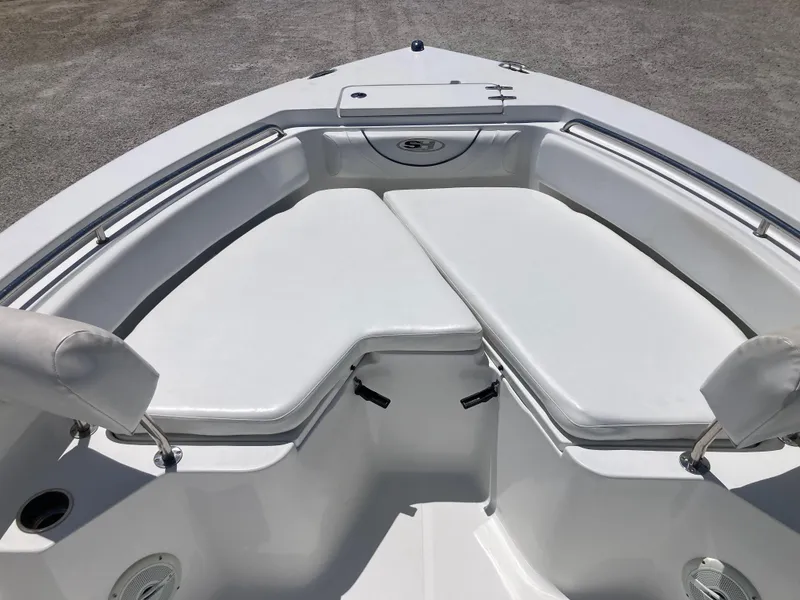 Slide: The Image of 2014 Sea Hunt 234 Ultra boat with white cushioned seating and storage compartment. - 9