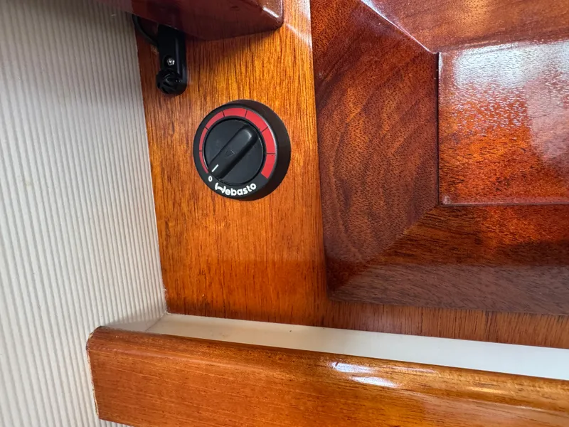 Slide: The Image of Webasto control knob on 2003 Camano Troll boat's polished wooden interior. - 14