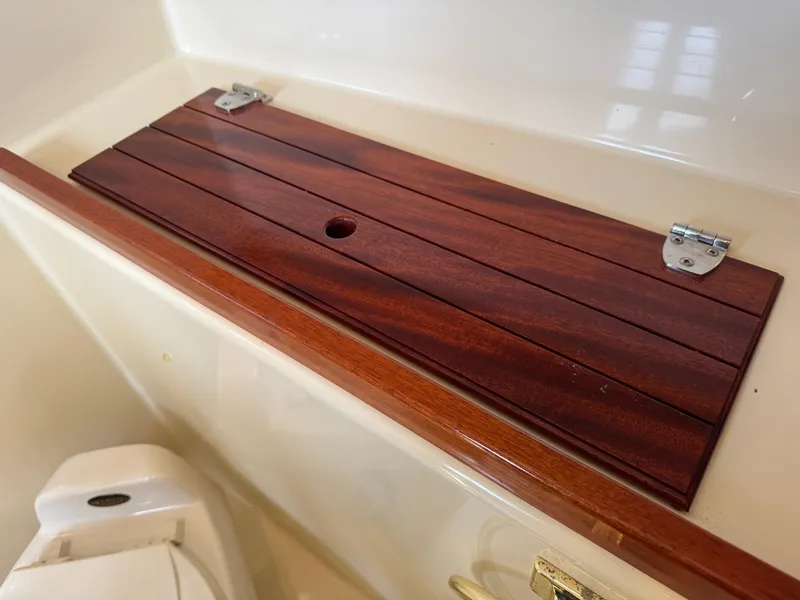 Slide: The Image of 2003 Camano Troll boat interior with wooden hatch cover and toilet. - 21