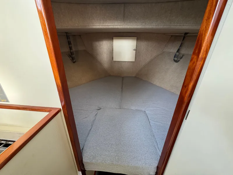 Slide: The Image of Cozy cabin interior of 2003 Camano Troll boat with gray bedding and wooden trim. - 22