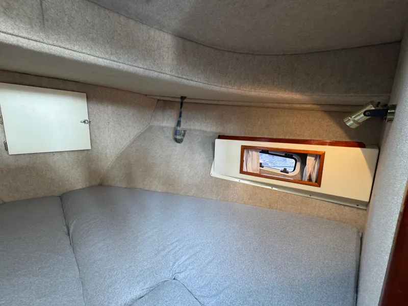 Slide: The Image of Cozy cabin interior of 2003 Camano Troll boat with window and storage. - 24