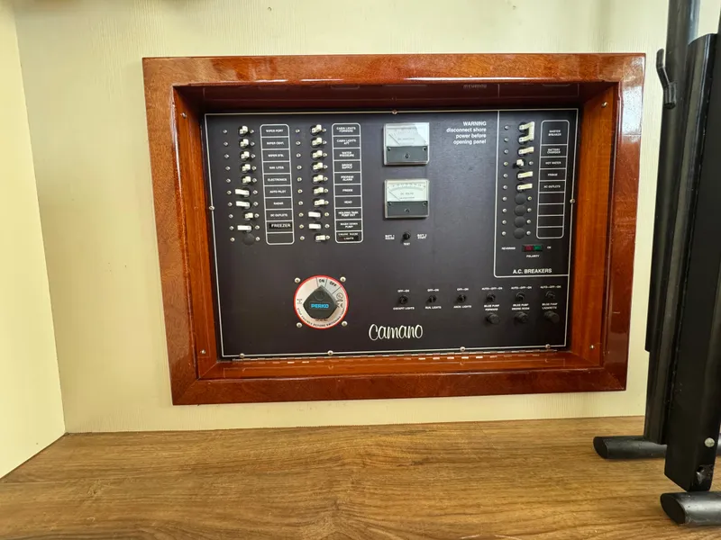 Slide: The Image of Electrical panel of a 2003 Camano Troll boat with switches and meters. - 27