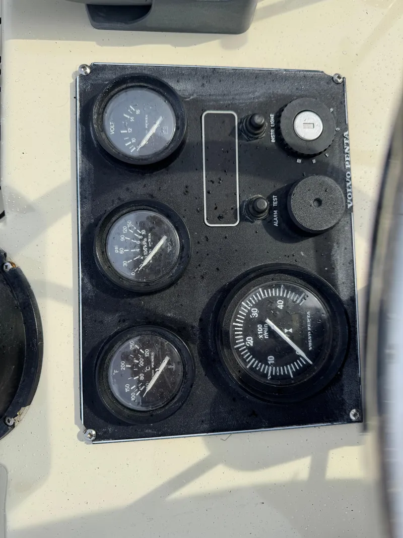 Slide: The Image of Control panel of a 2003 Camano Troll boat with gauges and switches. - 28