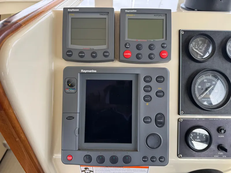 Slide: The Image of Control panel of a 2003 Camano Troll boat with Raymarine navigation instruments. - 32
