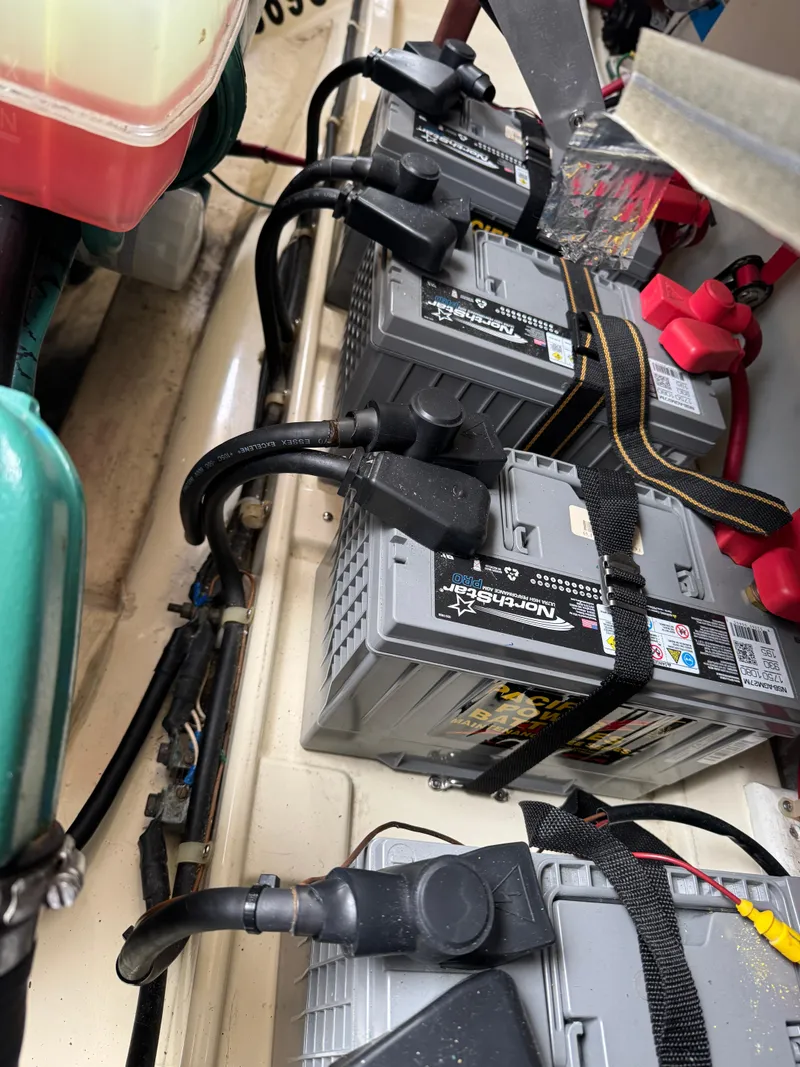 Slide: The Image of Batteries in a 2003 Camano Troll boat engine compartment, secured with straps. - 36