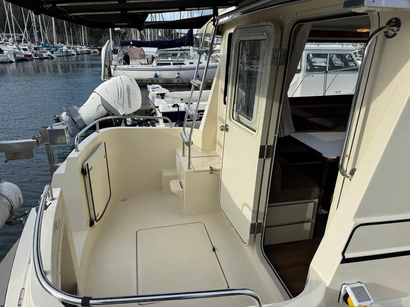 Slide: The Image of 2003 Camano Troll boat deck with open cabin door, docked at marina. - 5