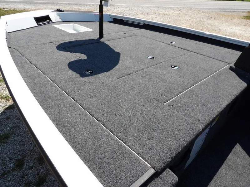 Slide: The Image of 2025 Crestliner XFC 189 boat deck with gray carpeting and storage compartments. - 10