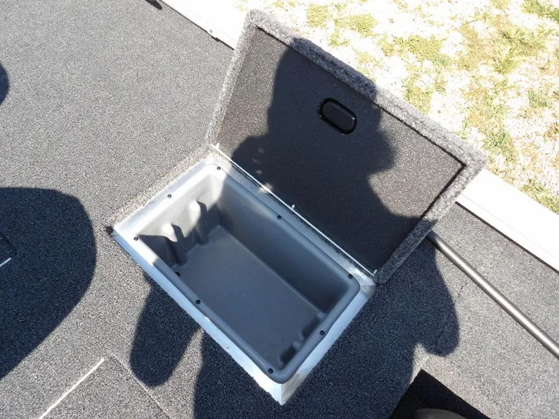 Slide: The Image of Open storage compartment in 2025 Crestliner XFC 189 boat, showing interior space. - 13