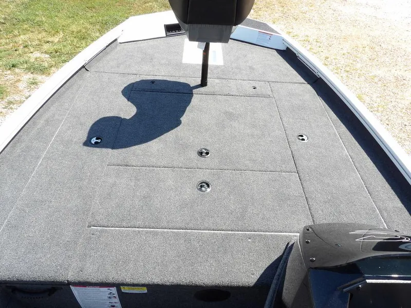Slide: The Image of 2025 Crestliner XFC 189 boat deck with carpeted surface and storage compartments. - 24