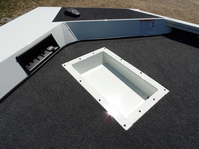 Slide: The Image of 2025 Crestliner XFC 189 boat deck with storage compartment and carpeted surface. - 30