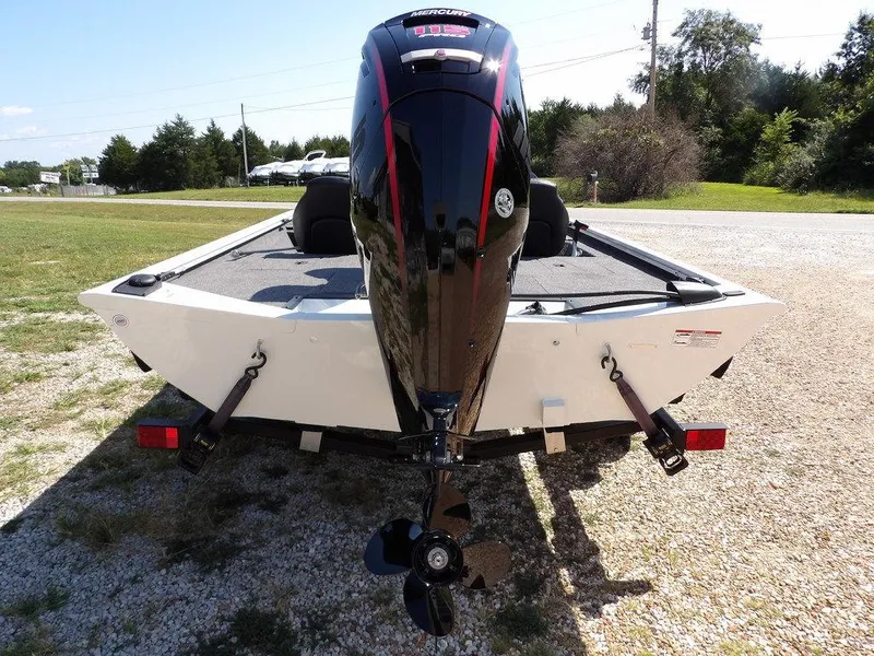 Slide: The Image of 2025 Crestliner XFC 189 boat rear view with outboard motor on gravel. - 6