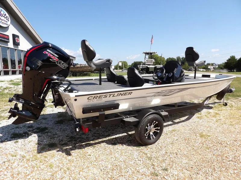Slide: The Image of 2025 Crestliner XFC 189 fishing boat on trailer, parked outdoors under clear sky. - 7