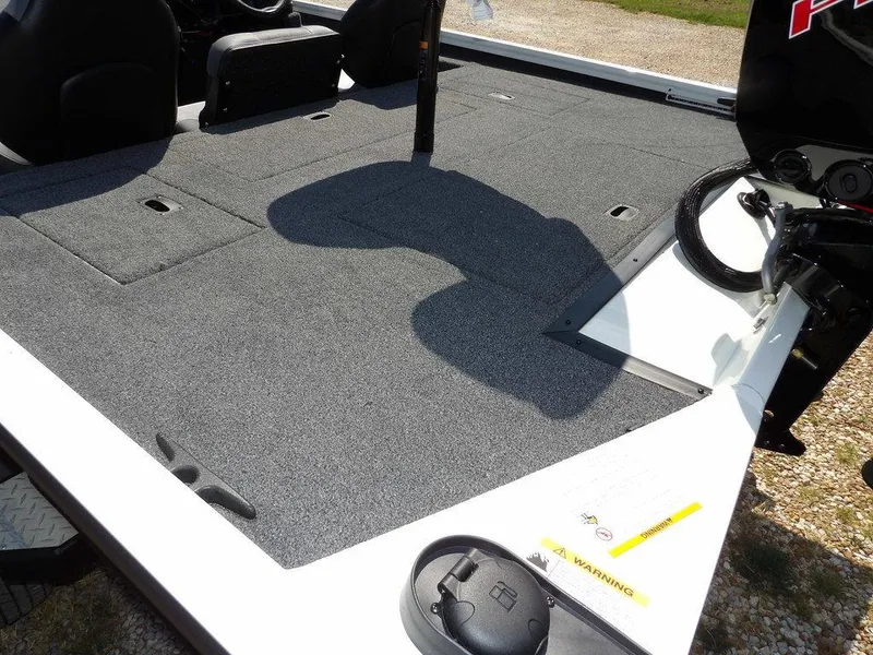 Slide: The Image of 2025 Crestliner XFC 189 boat deck with carpeted surface and storage compartments. - 9