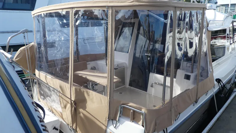 Slide: The Image of 2021 Ranger Tugs R-29 S with enclosed cockpit, docked at marina. - 10