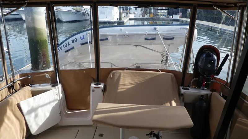 Slide: The Image of Interior view of 2021 Ranger Tugs R-29 S boat with seating and water backdrop. - 11